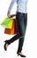 Woman hiding multicolored shopping paper bags