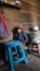 Woman from the high Andes cooking in small kitchen.