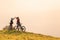 Woman high five over the sunset at mountain biking trip