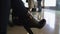 Woman in high-heeled boots waiting flight in airport, business trip, closeup