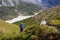 Woman hike with backpack at the lake of highlands of Altai mount