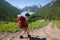 Woman hike with backpack at the lake of highlands of Altai mount