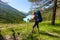 Woman hike with backpack at the lake of highlands of Altai mount