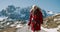 Woman hike in red jacket with backpack in winter journey mountain adventure