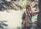 Woman hiker with backpack enjoying amazing mountain lake landscapes.