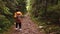 woman hiker backpacker walking by forest footpath