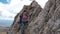 Woman Hiker Climbing Rock on Mountain Peak Cliff