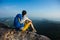 Woman hiker enjoy the view hiking on mountain peak