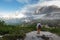 Woman hiker enjoy the view stand at cliff edge on mountain