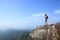 Woman hiker enjoy the view at sunset mountain peak