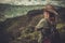 Woman hiker enjoying amazing valley landscapes on a top of mountain.