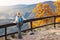 Woman hiker enjoying view to mountain at autumn season