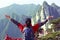 Woman hiker excited mountain peak