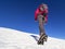 Woman hiker on a glacier with crampons on boots