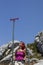 Woman hiker high in the the mountain resting under the sign post