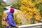 Woman hiker hiking looking at scenic view of fall foliage mountain river landscape . Adventure travel outdoors person standing