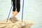 Woman hiker hiking stand on seaside rock