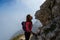 Woman hiker kissing a rock face in the Julian Alps, Slovenia, just under Mangart peak, after descending the via ferrata route.