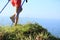 Woman hiker legs hiking on seaside mountain