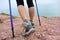 Woman hiker legs walking on seaside mountain trail