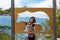 Woman hiker at mountain forest posing beside bear sign at natural reserve