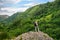 Woman hiker on mountain peak, person tourist on forest background