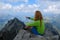 Woman hiker points her finger towards a summit in the High Tatras mountains, Slovakia. Hiking, trekking, adventure, active,
