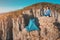 Woman hiker practices yoga and meditation next to her tent against the backdrop of a deep mountain gorge.