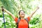 Woman hiker raised arms in jungle