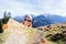 Woman hiker reading map in mountains