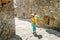 Woman hiker on a route trail across the old medieval town or village