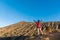 Woman hiker spreading hand, enjoy and happy with mountain top view after finished climbing at mount Rinjani