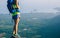 woman hiker stand on mountain peak cliff edge