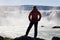 Woman Hiker Standing In Front Of a Huge Waterfall