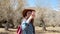 Woman hiker taking photo with cell phone at mountain peak