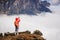 Woman hiker taking photo with smart phone on mountain peak