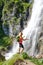 Woman hiker touching water drops at Dalfazer waterfall, Austria