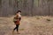 Woman hiker trekking in autumn forest. Cheerful blonde tourist girl, backpacker have walk through forest,  tourism concept