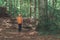 Woman hiker trekking and walking in forest