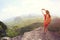 Woman hiker use smartphone taking photo on seaside mountain top