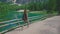 Woman hiker walking along the road near Lago di Braies