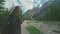 Woman hiker walking around the Braies lake and enjoys his spectacular sceneries, Dolomites, Italy