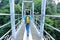 Woman hiker walking at bridge in mountain peak