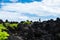 Woman hiker walks on the sharp volcanic land