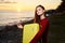 woman hiker yellow suitcase vacation mountains ocean sunset