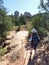 A Woman Hikes Toward Sedona`s Famous Cathedral Rock
