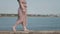 Woman hiking along a seashore