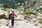 Woman hiking with backpack in Corsica mountains