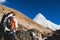 Woman hiking with backpack in Himalaya Mountains. Trekking to Everest Base Camp.