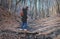 Woman hiking crossing creek in woods